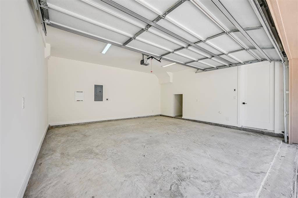 2247 Mail Avenue, #101, Dallas, TX 75235 Two-car garage with concrete flooring, automatic garage door opener, recessed lighting, and a utility door