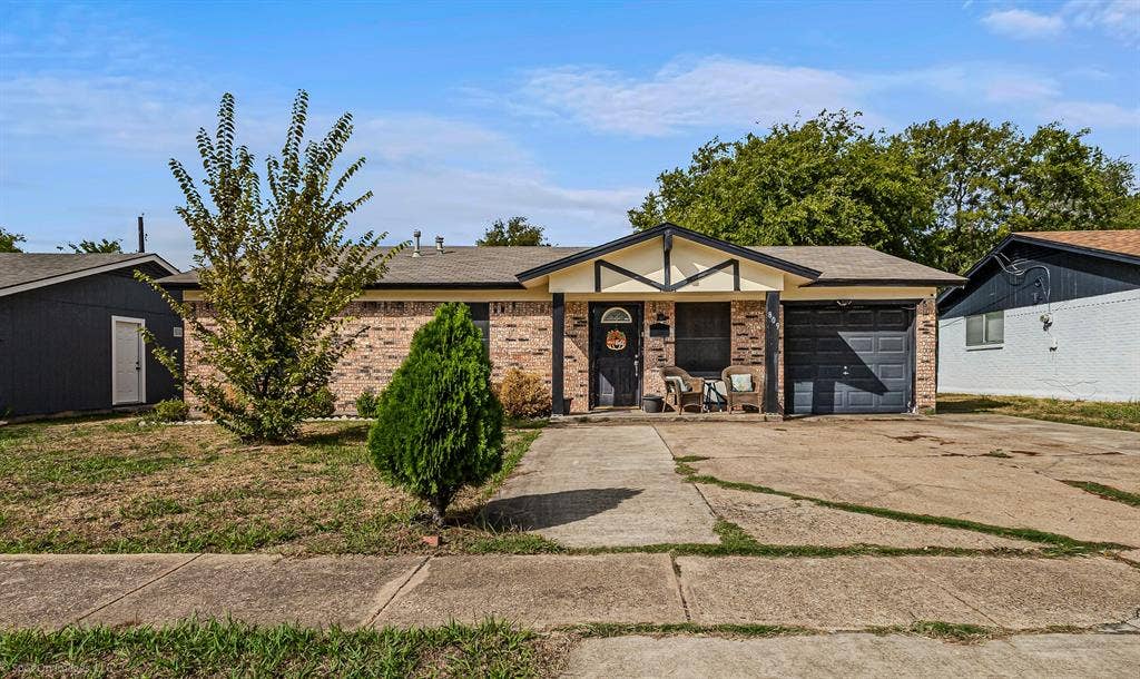 Single-story residence featuring a brick facade, covered front entryway, attached one-car garage, and concrete driveway