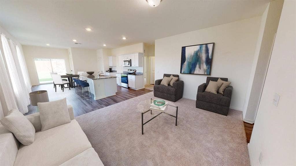 6053 Mojave Drive, Forney, TX 75126 Open-concept living space with recessed lighting, wood-finish flooring, a kitchen island with seating, and a dining area