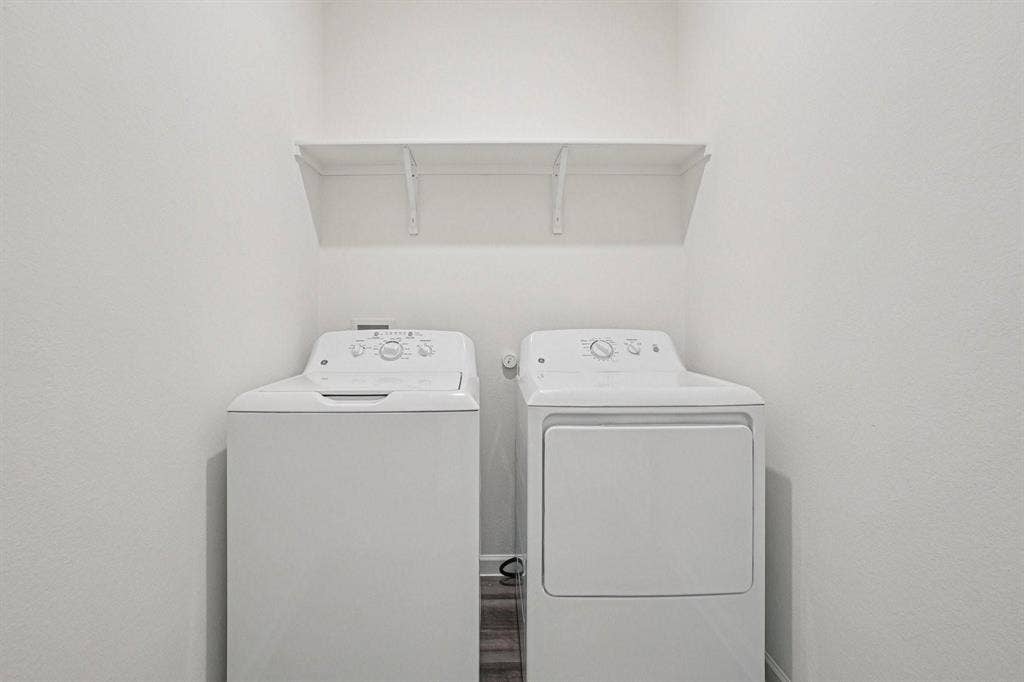 6053 Mojave Drive, Forney, TX 75126 White top-load washing machine and front-load dryer with an overhead shelf