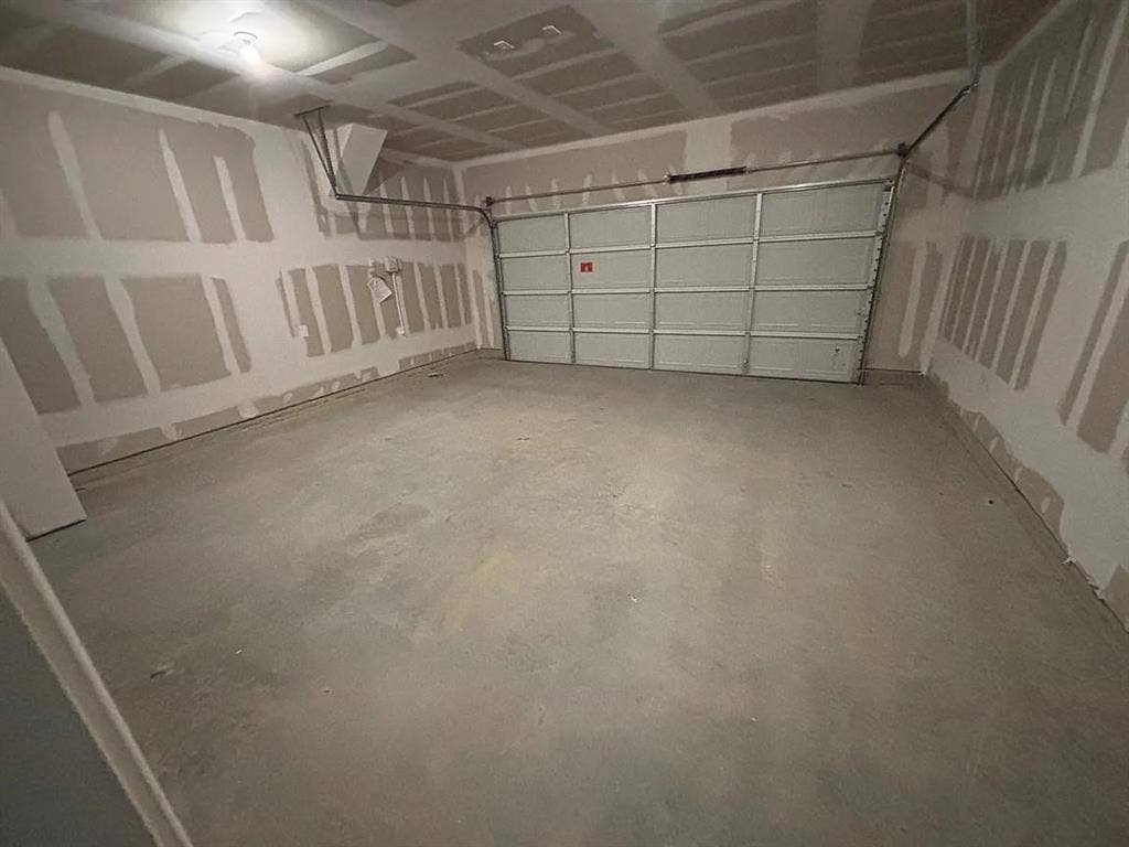 5944 Sahara Drive, Forney, TX 75126 Attached garage featuring a concrete floor and a panel garage door