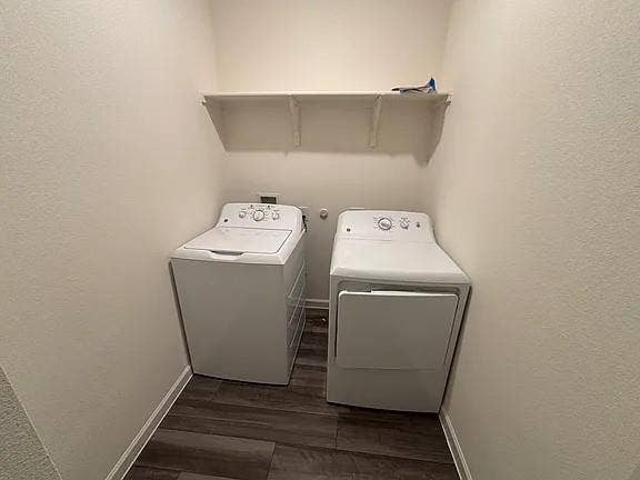 5944 Sahara Drive, Forney, TX 75126 Laundry area featuring wood-finish flooring and a wall-mounted storage shelf