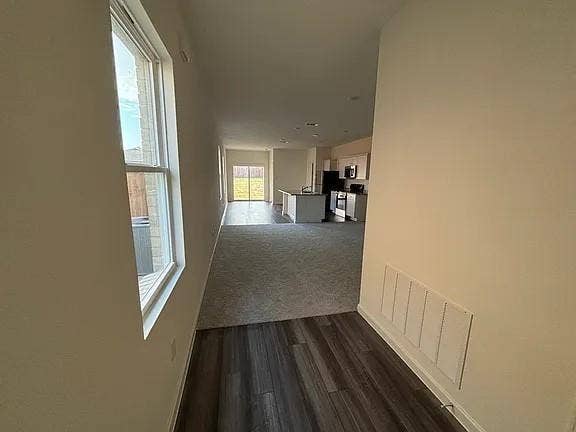 5944 Sahara Drive, Forney, TX 75126 Wood-finish flooring, light-toned walls, and a large window