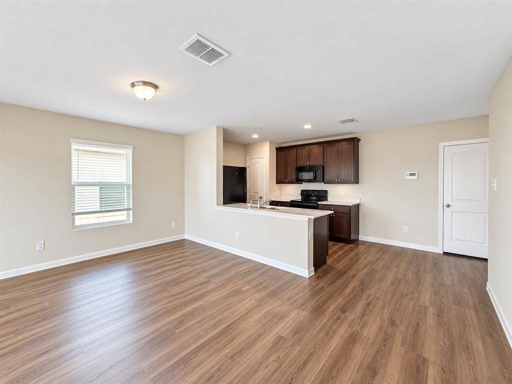 9226 Summerlee Street, Dallas, TX 75227 Open-concept living space with wood-finish flooring