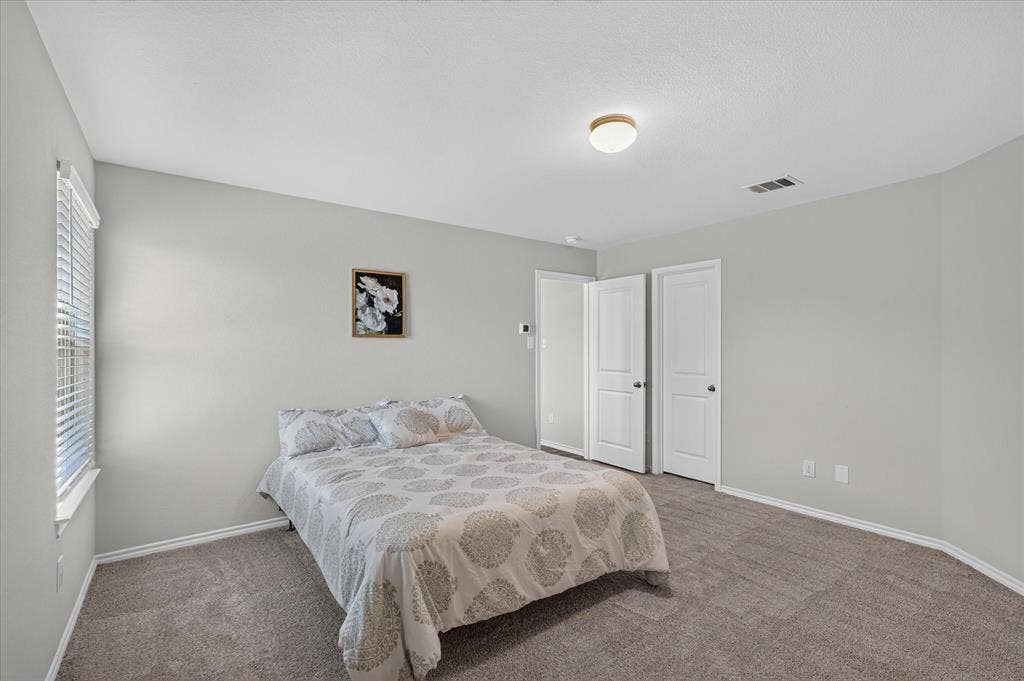 2428 Rosharon Drive, Forney, TX 75126 Neutral-toned walls complement plush carpeting