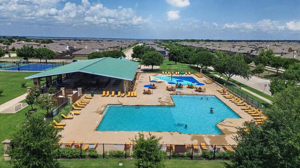 2428 Rosharon Drive, Forney, TX 75126 Expansive community recreational area featuring multiple swimming pools, a covered pavilion, sports courts, and manicured green spaces