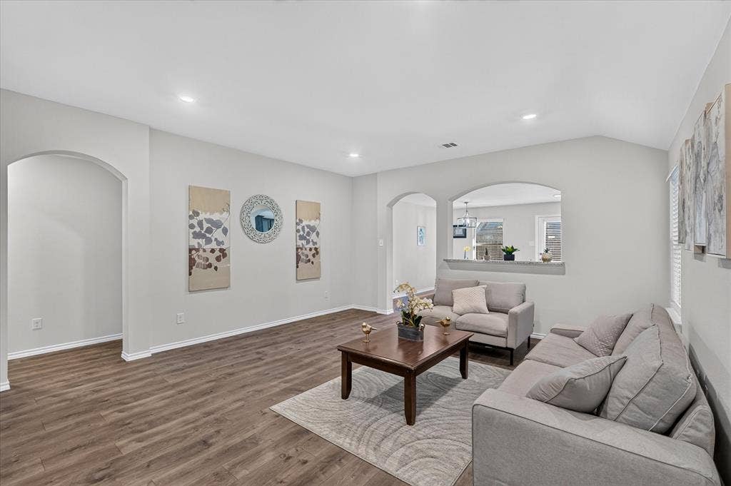 2428 Rosharon Drive, Forney, TX 75126 Vaulted ceilings, recessed lighting, wood-finish flooring, arched doorways, and an interior pass-through window