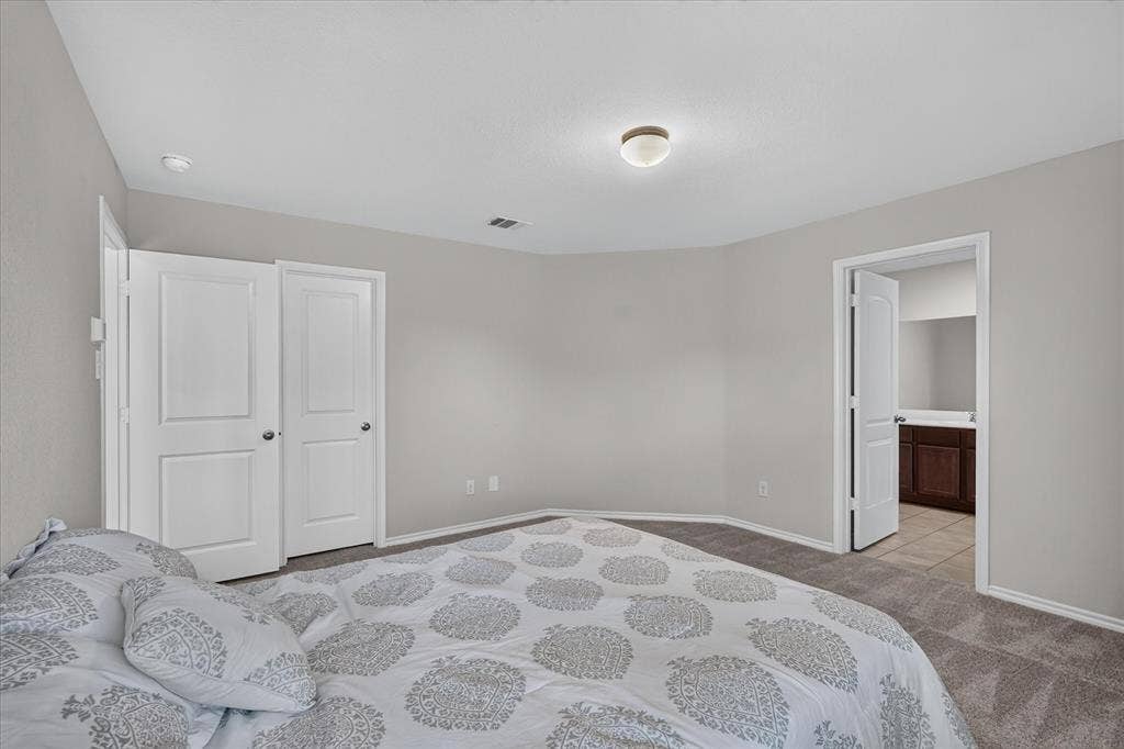 2428 Rosharon Drive, Forney, TX 75126 Wall-to-wall carpeting, light neutral wall paint, overhead flush-mount lighting, and bi-fold closet doors