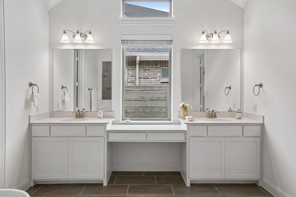 Dual vanity with white cabinetry, integrated sinks, white countertops, and brushed nickel fixtures