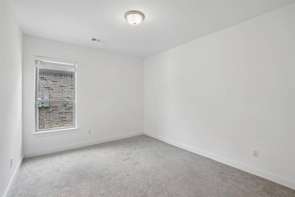 Neutral wall finishes, recessed window, wall-to-wall carpeting, and a ceiling-mounted light fixture