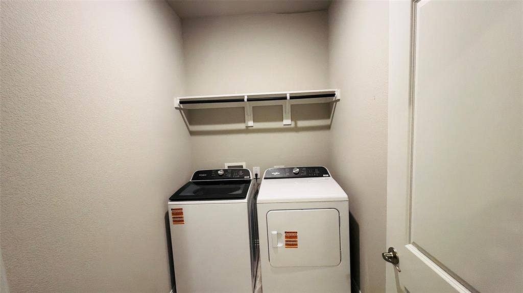 505 Blanton Street, McKinney, TX 75069 Laundry area with built-in shelving and hanging rod
