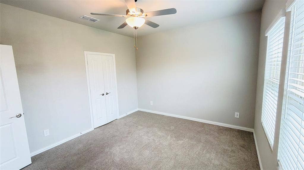 505 Blanton Street, McKinney, TX 75069 Carpeted flooring, ceiling fan with integrated lighting, window with blinds, and white panel doors