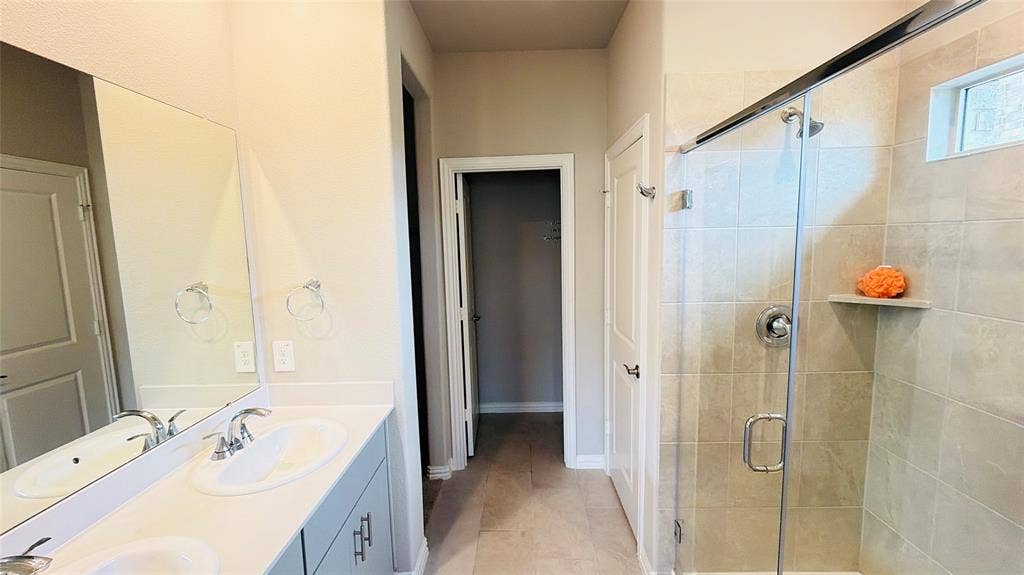 505 Blanton Street, McKinney, TX 75069 Double vanity with integrated sinks, chrome fixtures, and light-toned cabinetry