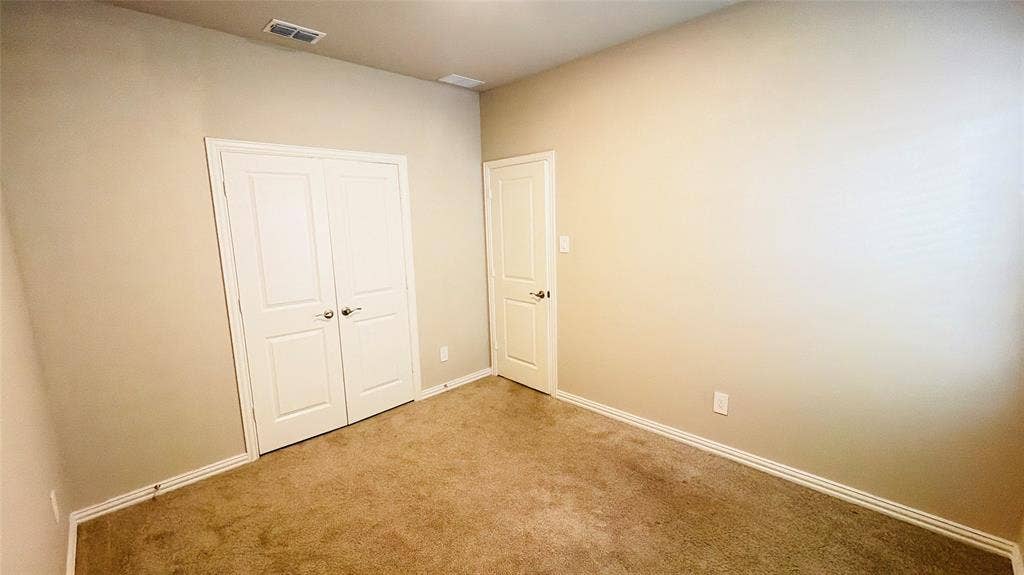 505 Blanton Street, McKinney, TX 75069 Neutral-toned walls complement plush carpeting