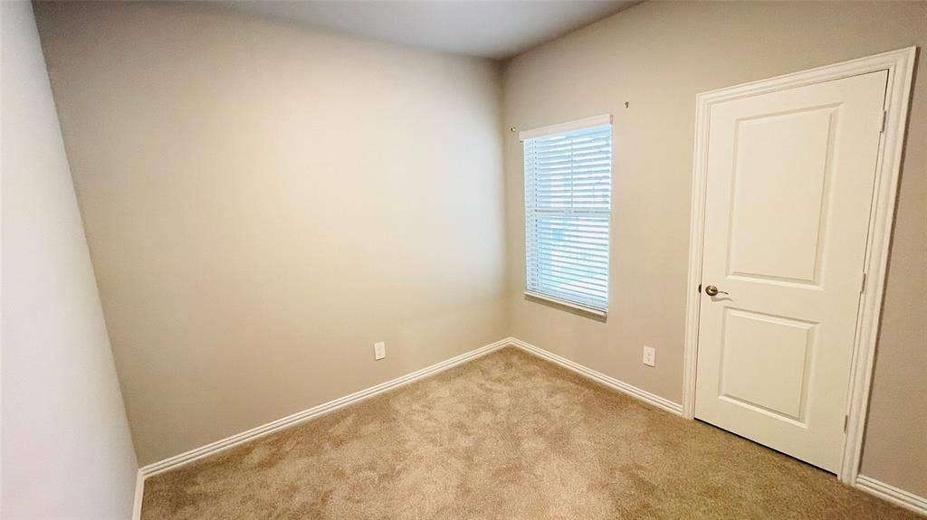 505 Blanton Street, McKinney, TX 75069 Carpeted flooring, neutral wall paint, white trim, window with blinds, paneled door