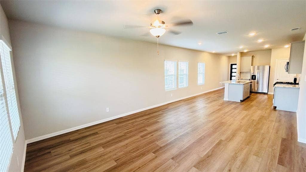 505 Blanton Street, McKinney, TX 75069 Open concept living area featuring wood-finish flooring, recessed lighting, and a ceiling fan