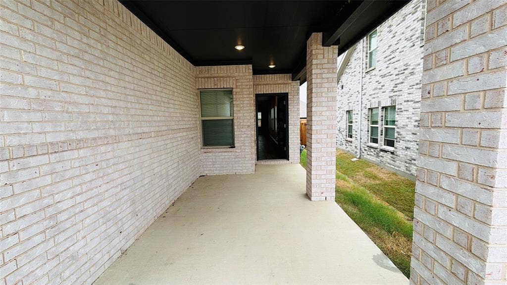 505 Blanton Street, McKinney, TX 75069 Covered patio featuring a concrete slab, recessed lighting, and a white brick exterior