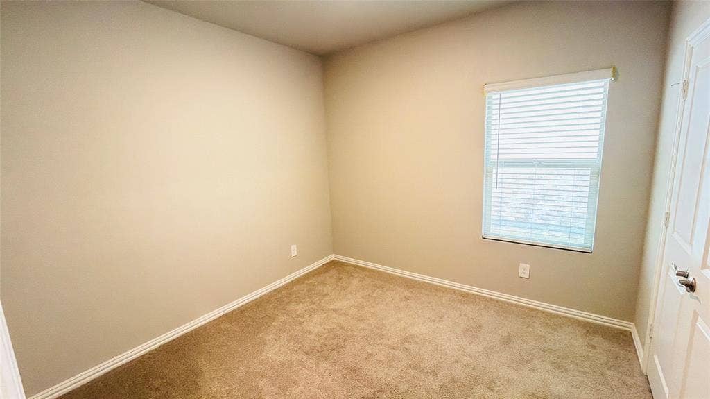 505 Blanton Street, McKinney, TX 75069 Neutral tone wall finishes, carpeting, and a window with blinds