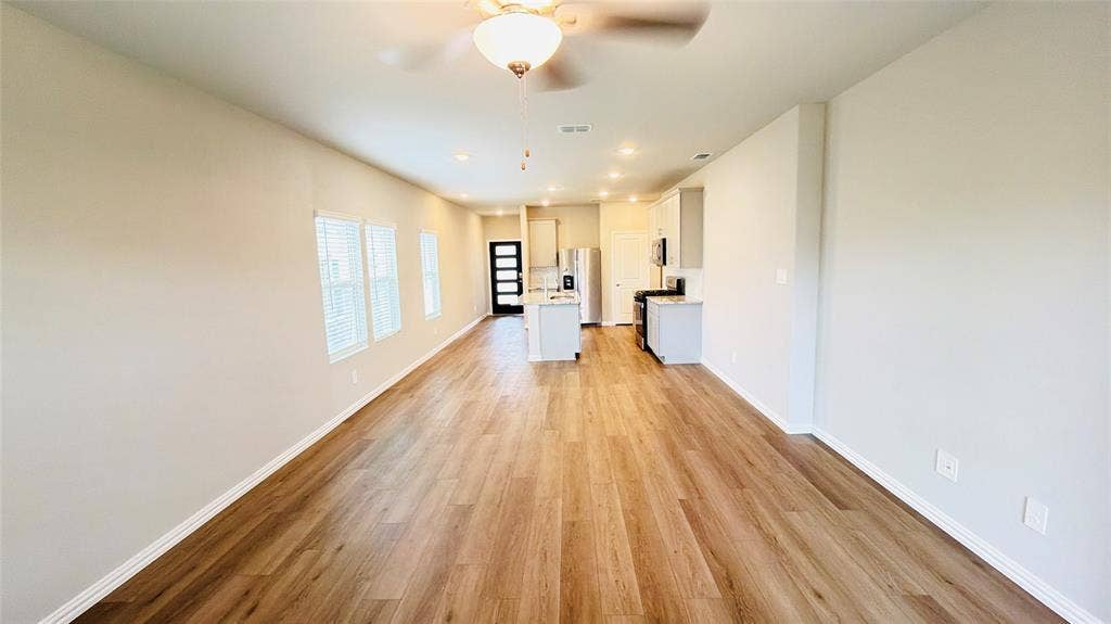 505 Blanton Street, McKinney, TX 75069 Spacious living area featuring wood-finish flooring, recessed lighting, and a ceiling fan