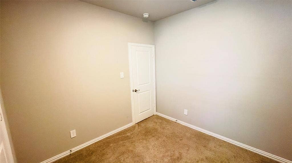 505 Blanton Street, McKinney, TX 75069 Carpeted flooring, light-colored walls, white trim, and a white door with a dark handle