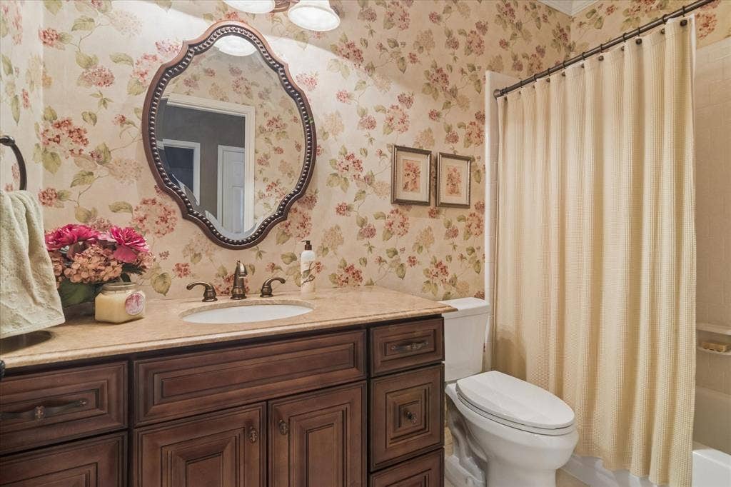 10521 Chablis Lane, Frisco, TX 75035 Vanity with decorative cabinetry, undermount sink, and bronze-finish faucet