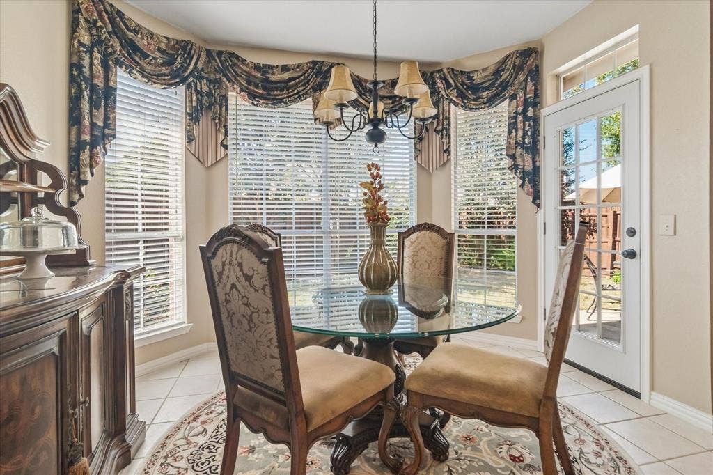 10521 Chablis Lane, Frisco, TX 75035 Bay window with horizontal blinds, tiled flooring, built-in buffet, and a paneled glass-insert door