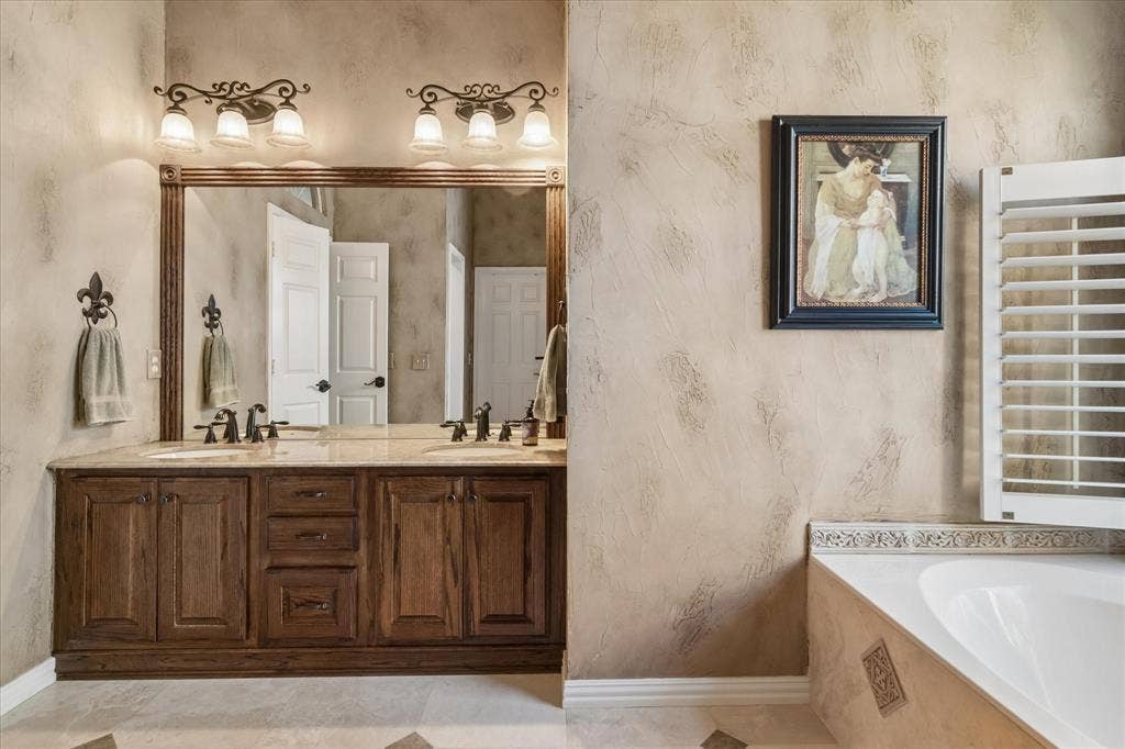 10521 Chablis Lane, Frisco, TX 75035 Dual vanity with wood-finish cabinetry and light-toned countertops