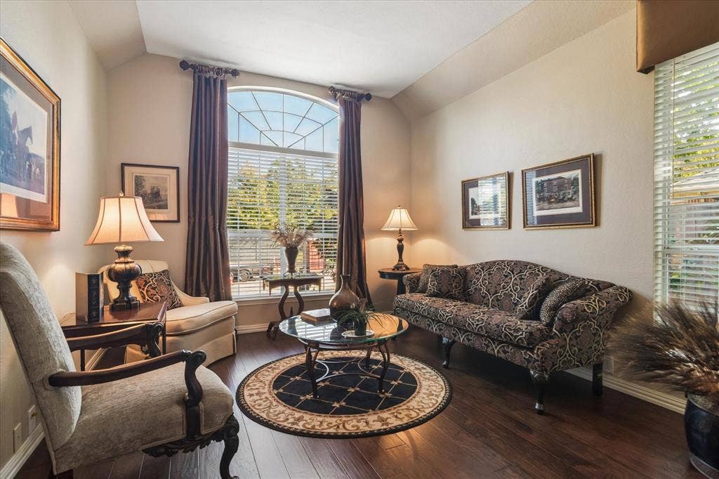 10521 Chablis Lane, Frisco, TX 75035 Arched window with gridded upper pane, wood-finish flooring, and light-toned wall paint
