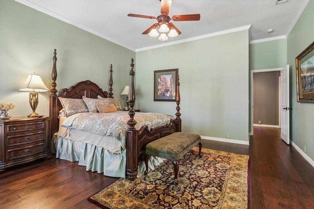 10521 Chablis Lane, Frisco, TX 75035 Hardwood flooring, painted walls, crown molding, ceiling fan, and recessed doorway