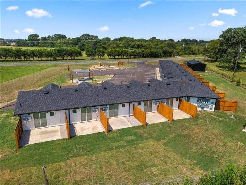 900 S Tool, #12, Tool, TX 75143 Single-story multi-unit structure with individual rear patios, and private wooden fence dividers