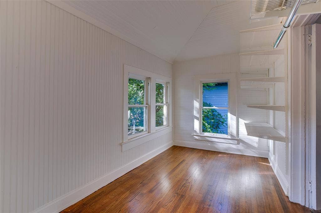 Once an upstairs sleeping porch off the northwest corner bedroom, this space now serves as a huge walk-in closet. Additional Elfa closet materials remain.