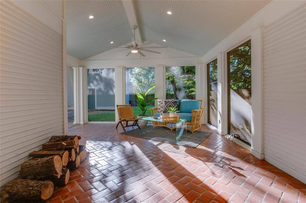 Rear screened porch with Saltillo tile flooring, set in a pretty herringbone pattern, and vaulted ceiling with recessed lighting.