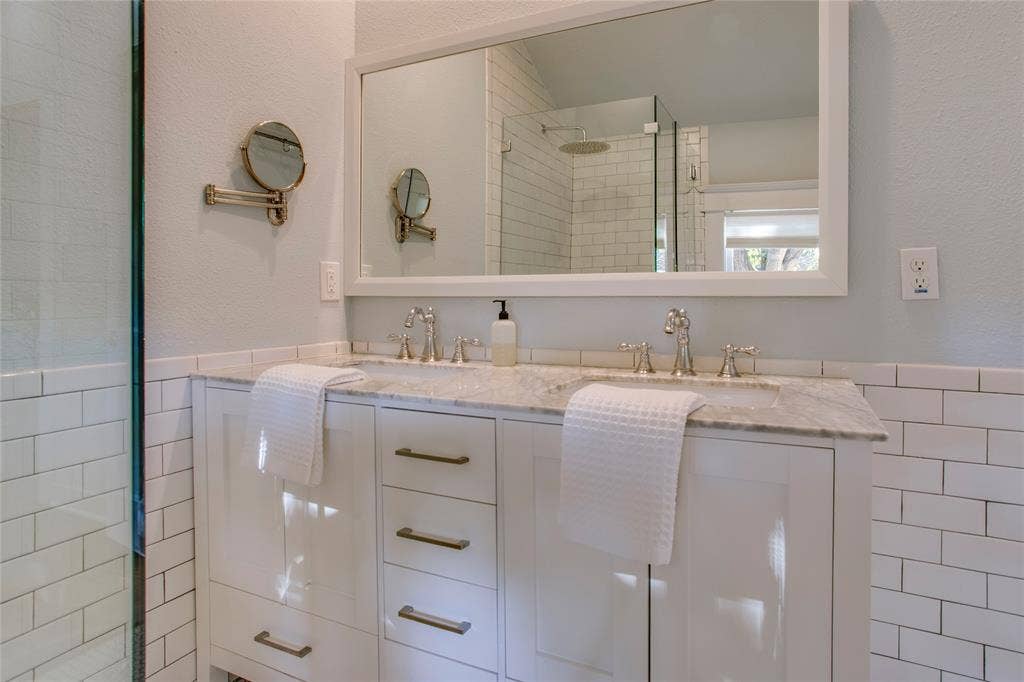 Note the dual sinks and walk-in glass shower