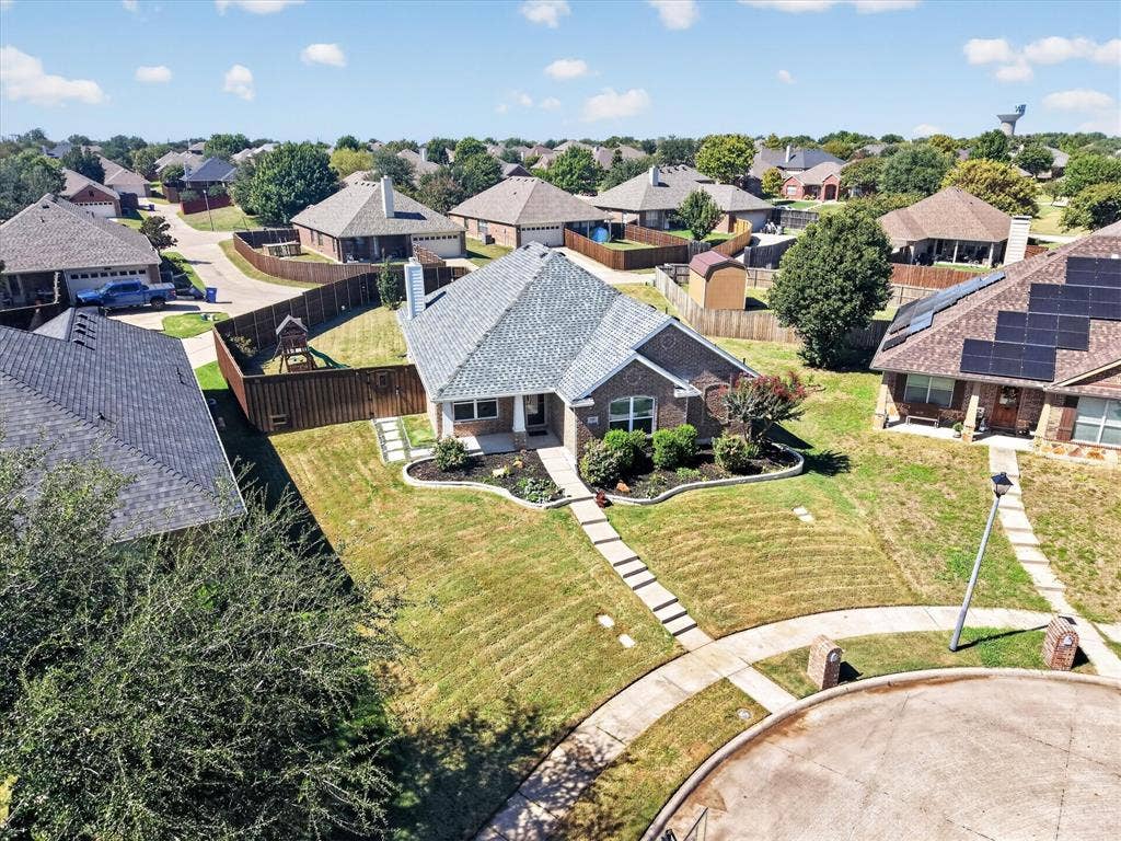 209 Northridge Drive, Wylie, TX 75098 Expansive manicured lawn with mature landscaping and curved hardscape pathways, anchored by a charcoal-toned architectural shingle roof