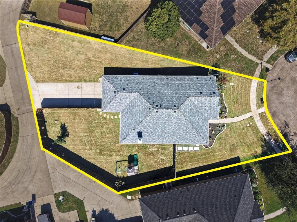 209 Northridge Drive, Wylie, TX 75098 Pitched roof residence featuring a concrete driveway and walkway, bordered by a manicured lawn and landscaping