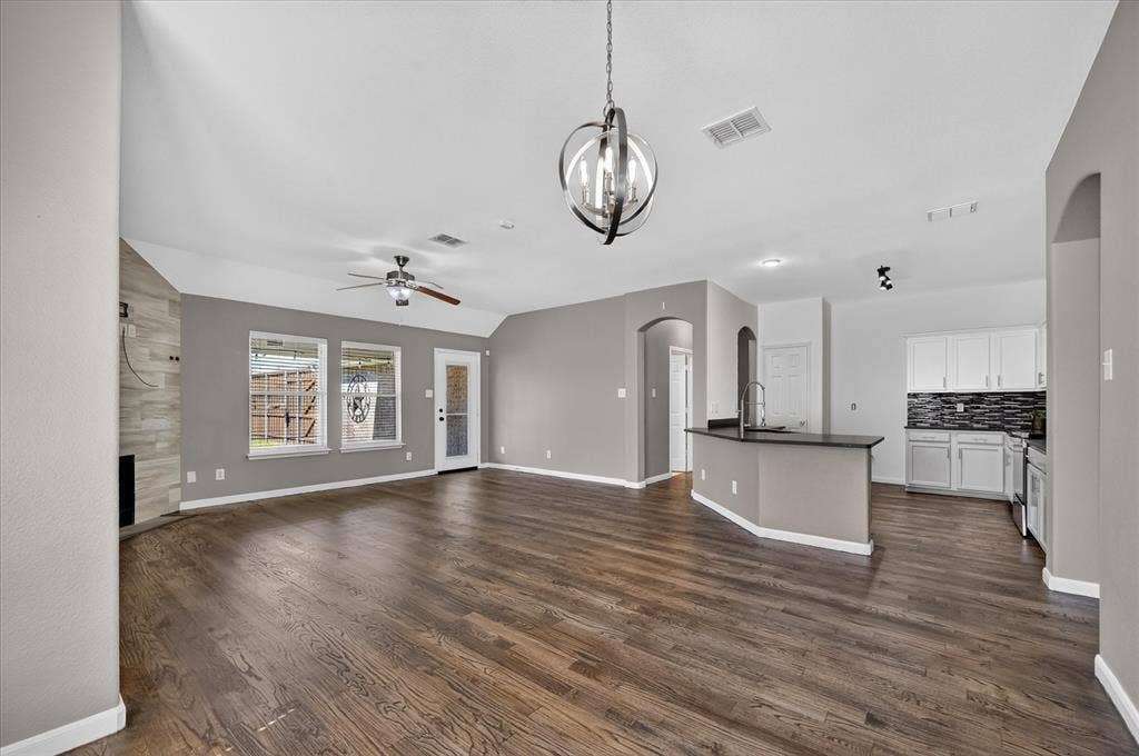 209 Northridge Drive, Wylie, TX 75098 Wood-finish flooring throughout, vaulted ceilings, and a decorative pendant light fixture