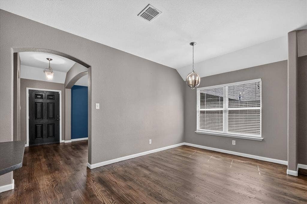 209 Northridge Drive, Wylie, TX 75098 Wood-finish flooring throughout, arched entryway, and a prominent window with blinds