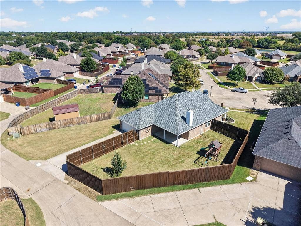 209 Northridge Drive, Wylie, TX 75098 Expansive backyard retreat featuring a manicured lawn, mature landscaping, and wood-finish privacy fencing