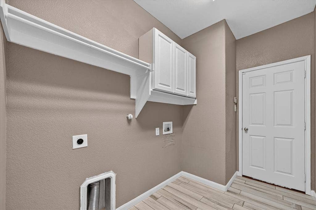 209 Northridge Drive, Wylie, TX 75098 White paneled cabinetry, wood-finish flooring, and white interior door
