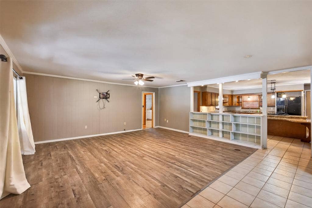 9468 Ranch Lane, Shreveport, LA 71106 Spacious interior with wood-finish flooring, ceiling fan, and built-in shelving
