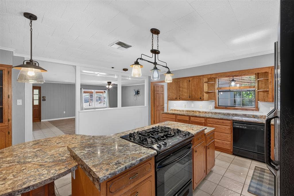 9468 Ranch Lane, Shreveport, LA 71106 Kitchen featuring wood cabinetry, a built-in oven with a gas cooktop, a double basin sink, and pendant lighting fixtures