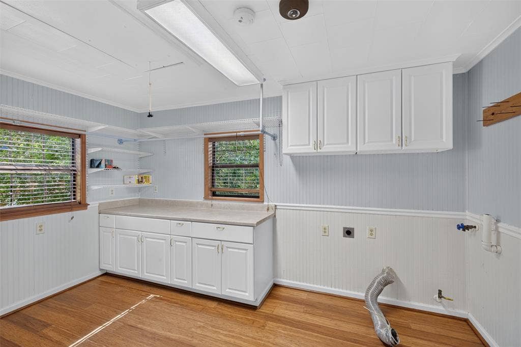 9468 Ranch Lane, Shreveport, LA 71106 Wood-finish flooring with beadboard wainscoting and two windows