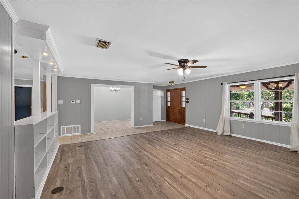9468 Ranch Lane, Shreveport, LA 71106 Spacious room with wood-finish flooring, paneled walls, and a ceiling fan