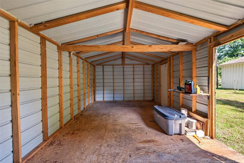 9468 Ranch Lane, Shreveport, LA 71106 Open-sided structure with a metal roof, wood framing, and plywood flooring
