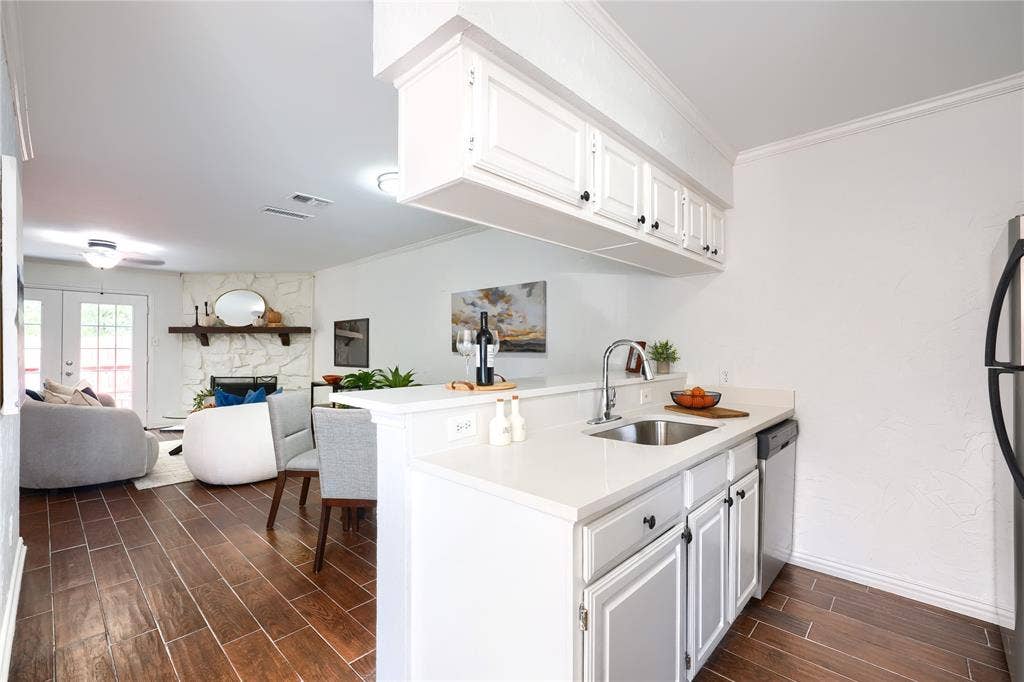 1600 Brentwood Drive, Irving, TX 75061 Kitchenette with white cabinetry, stainless steel sink, and light-toned countertops