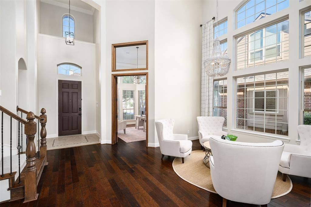Two-story entry with dark wood-finish flooring