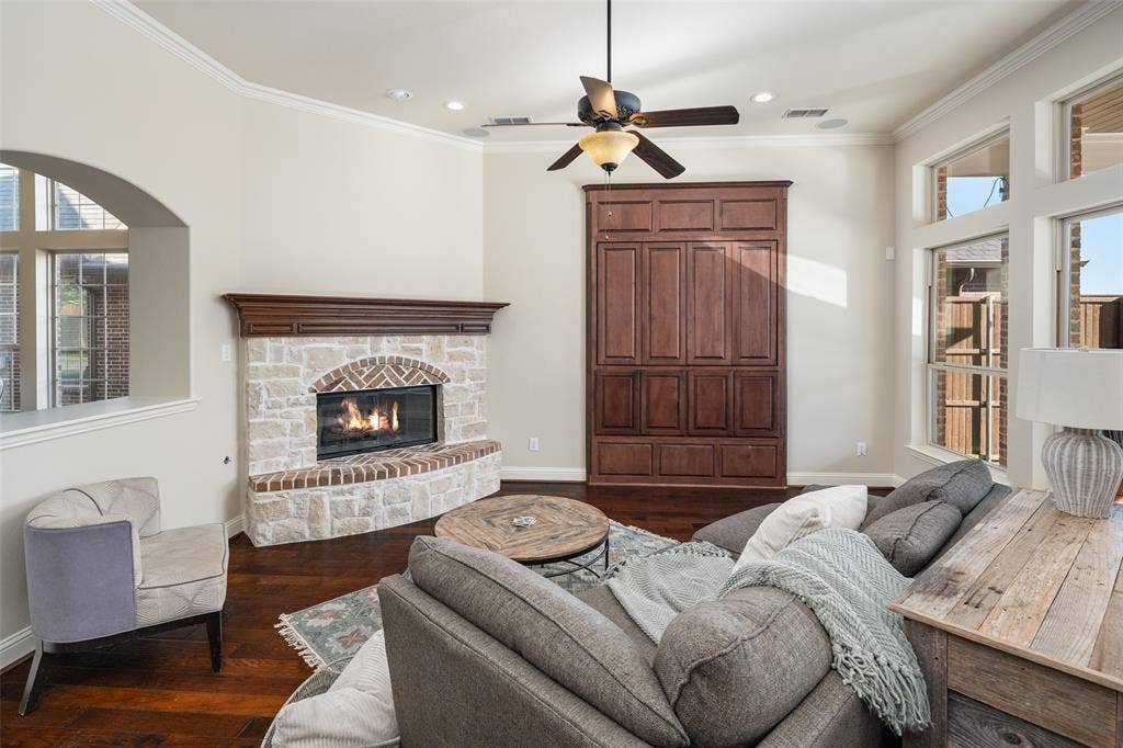 Stone and brick fireplace with a wood mantle