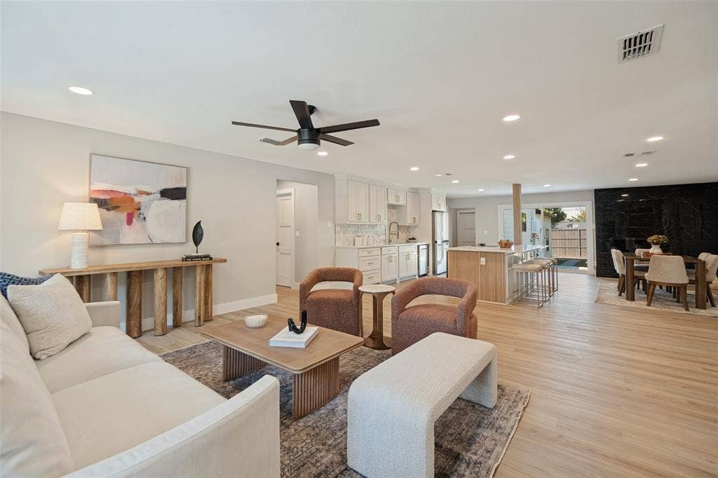 3129 Flowerdale Lane, Dallas, TX 75229 Open-concept living space featuring wood-finish flooring, recessed lighting, and a contemporary ceiling fan