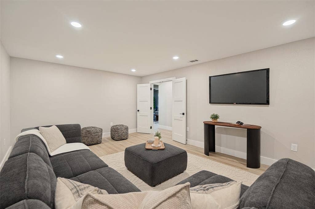 3129 Flowerdale Lane, Dallas, TX 75229 Recessed lighting illuminates neutral walls and wood-finish flooring