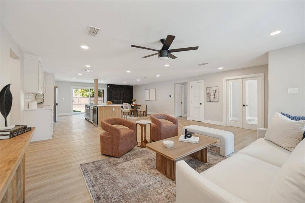3129 Flowerdale Lane, Dallas, TX 75229 Open-concept living area featuring wood-finish flooring, recessed lighting, and a contemporary ceiling fan